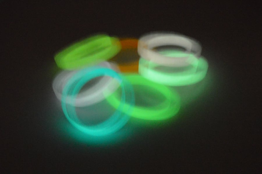 A stack of silicone wristbands that glow in the dark.