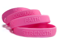 4 pink embossed custom wristbands with personal messages.