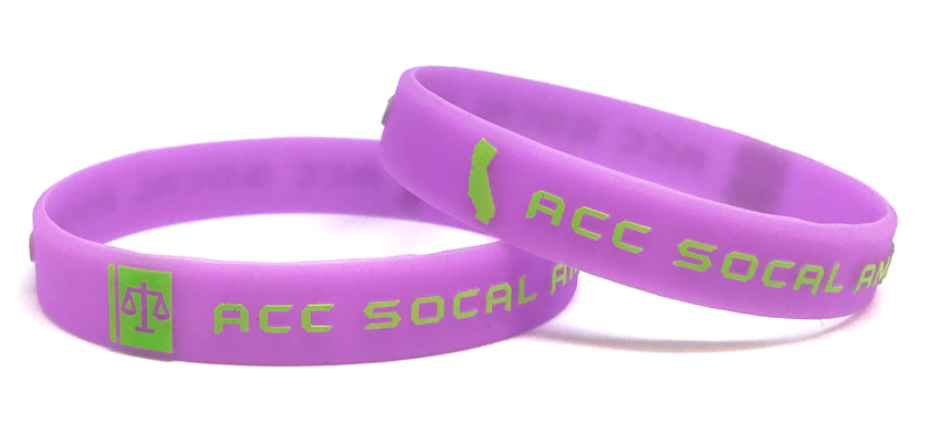 Two purple custom wristbands with personal messages.