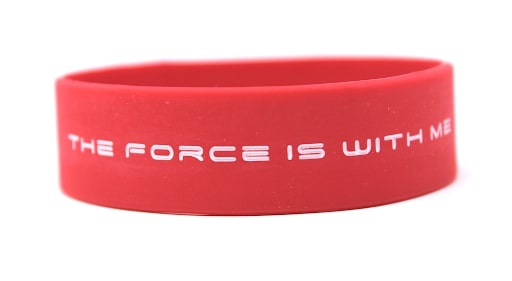 Red silicone wristband with the message the force is with me in white letters.