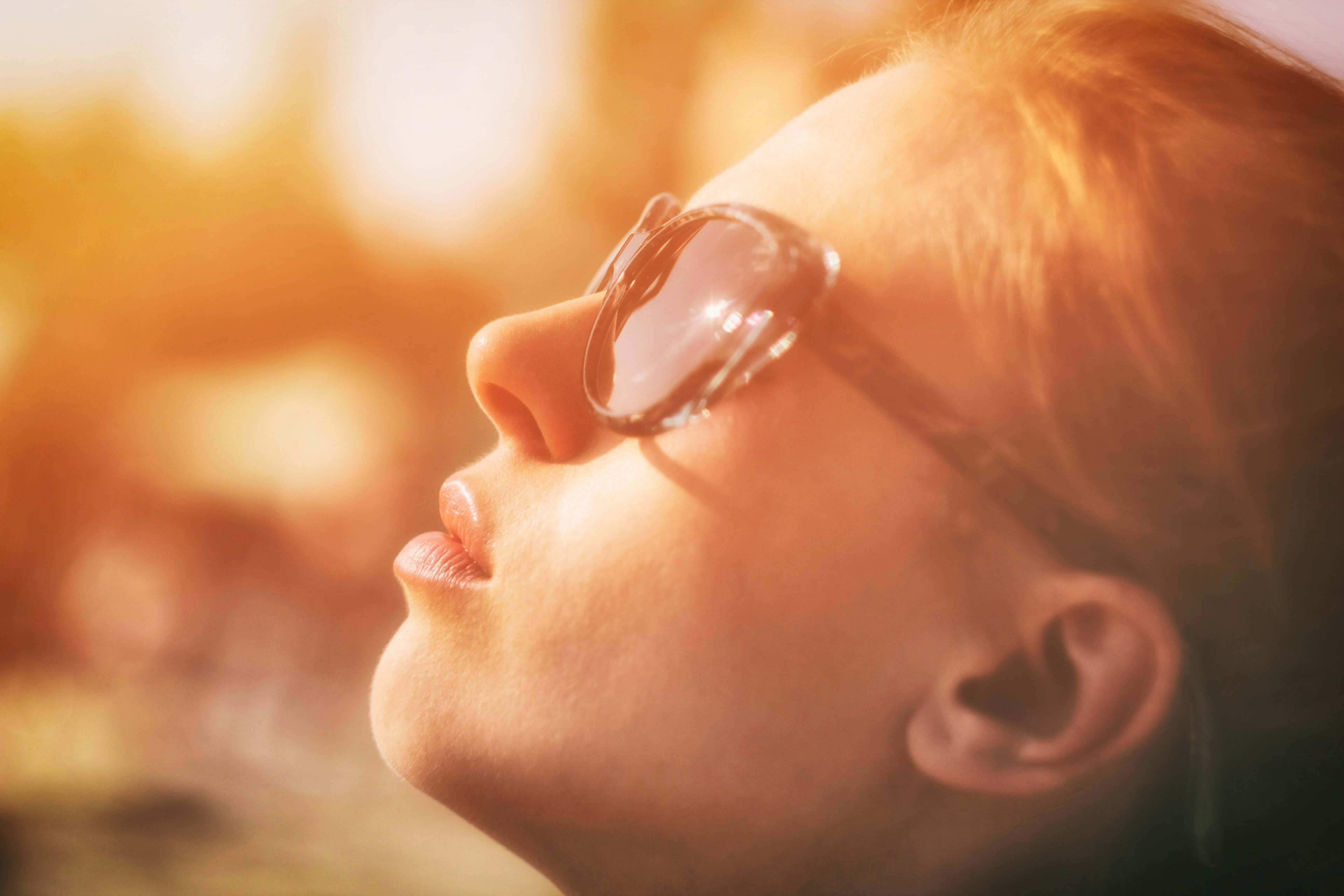 woman bathing in the sun at risk for skin cancer