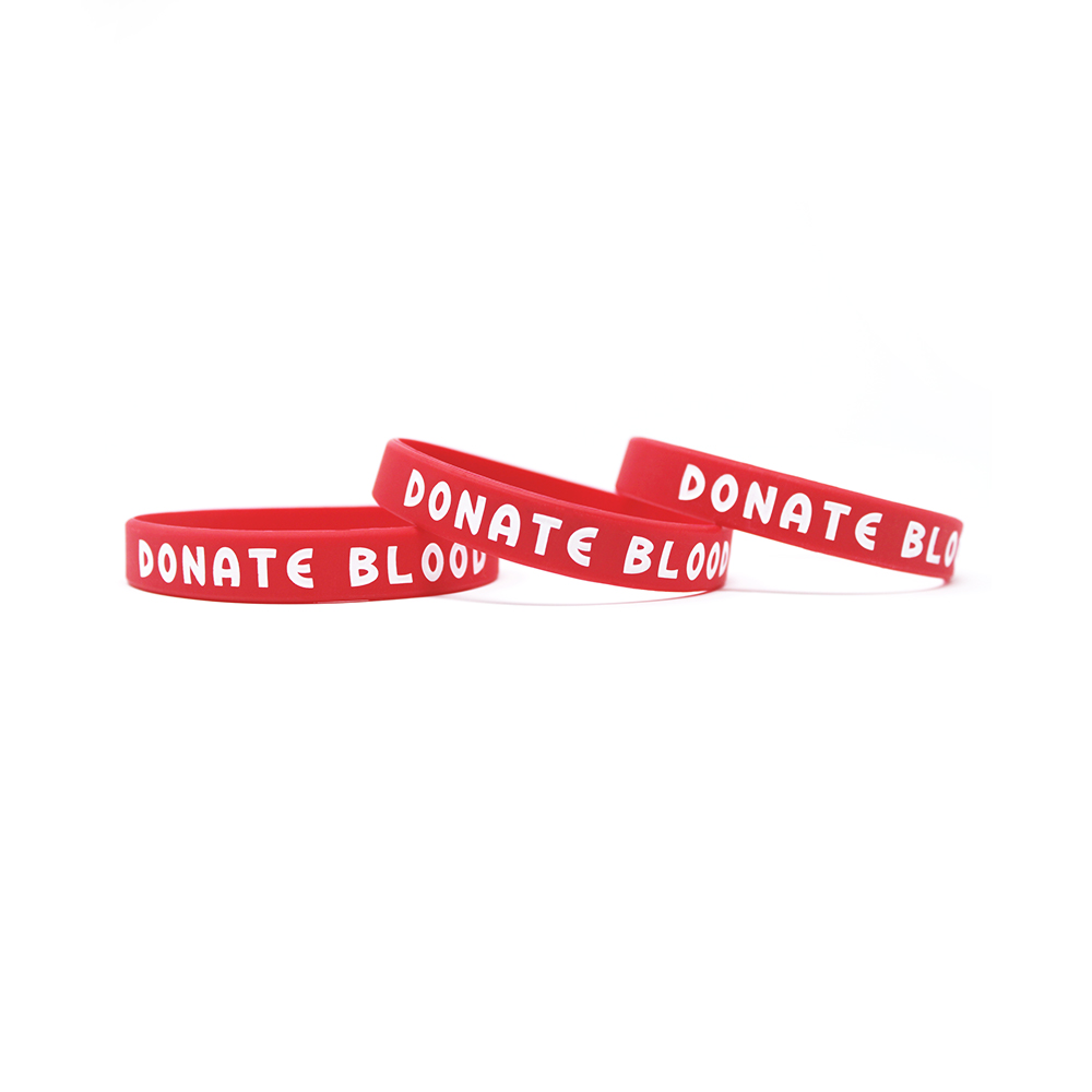 Red printed wristbands that say donate blood.