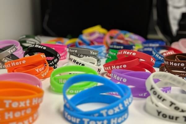 A row of silicone wristbands in various colors.